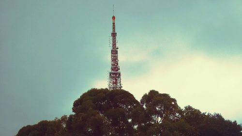 Low angle view of communications tower against sky