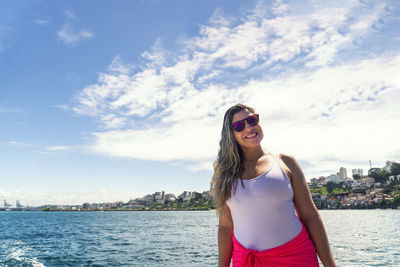 A woman on top of a boat against the sea in the background. salvador, bahia, brazil.