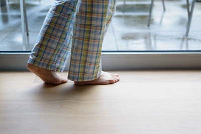 Low section of woman standing on floor