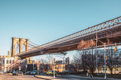 View of brooklyn bridge against clear blue sky during sunny day