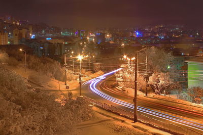 High angle view of light trails on bridge at night