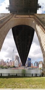 Arch bridge over river in city