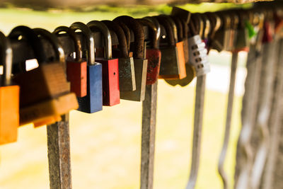 Close-up of padlocks hanging on metal structure
