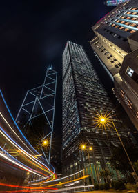 Low angle view of illuminated buildings against sky at night