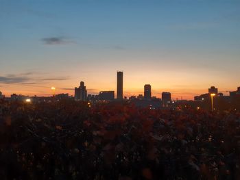 City buildings against sky during sunset