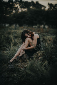 Young woman relaxing on grassy field