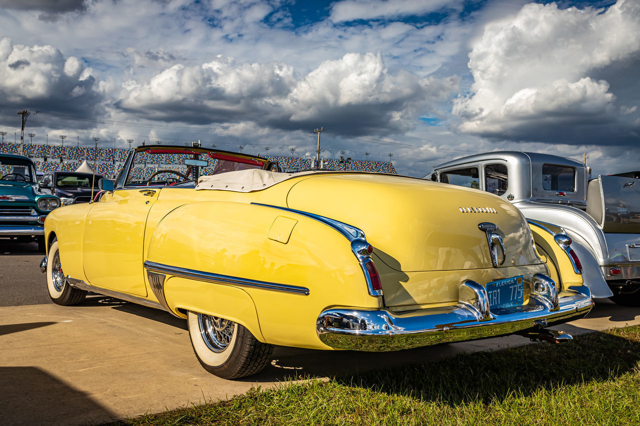 VIEW OF YELLOW CAR ON ROAD