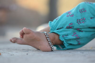 Midsection of woman lying on floor