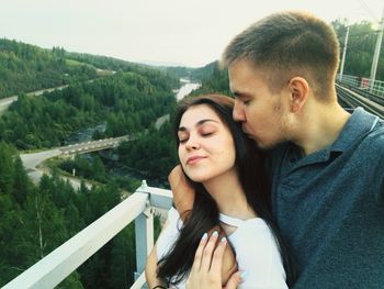 Young couple against sky