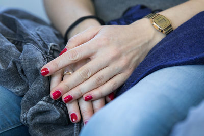 Midsection of woman with red nail polish