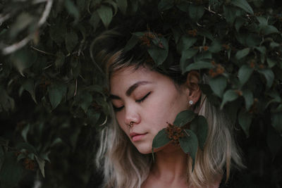 Close up of young woman lying on grass