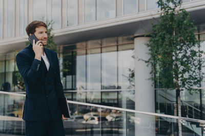 Full length of man using mobile phone