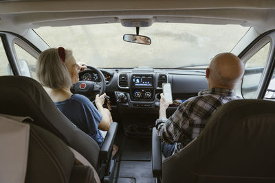 Senior couple on road trip in camper van