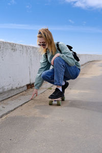 Full length of woman standing on road