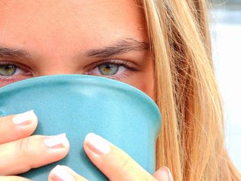 Close-up portrait of woman drinking tea