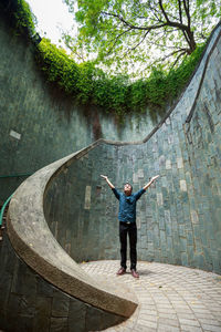 Rear view of man standing by wall