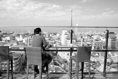 Rear view of man looking at cityscape