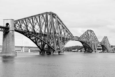 View of bridge over river against cloudy sky