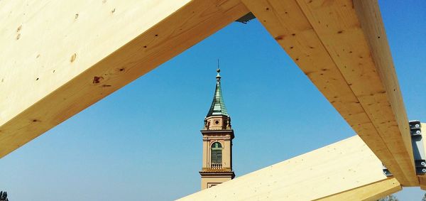 Low angle view of bell tower against blue sky