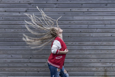 Blonde woman with dreadlocks wagging her hair