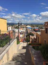 Street amidst buildings in town against sky