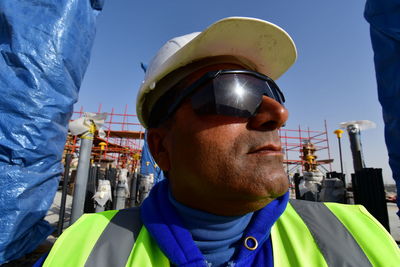 Close-up of man wearing sunglasses against built structure