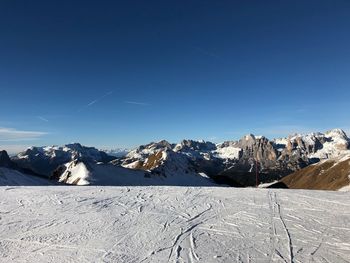 Scenic view of snowcapped mountains against clear blue sky