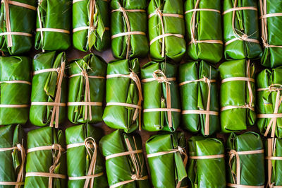 Full frame shot of food wrapped in banana leaves for sale at market stall