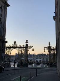 People on street in city against clear sky