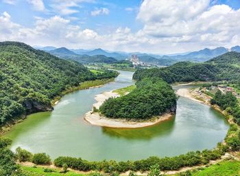 High angle view of river against cloudy sky