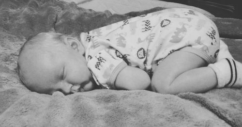 Close-up of baby sleeping on bed