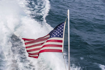 Close-up of flag against sea