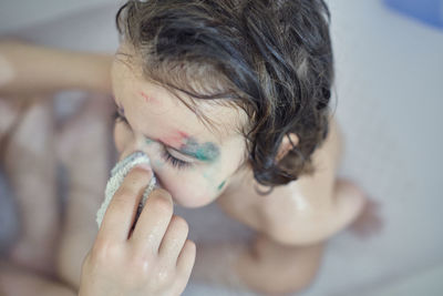 Girl bathing in the tub with her older brother