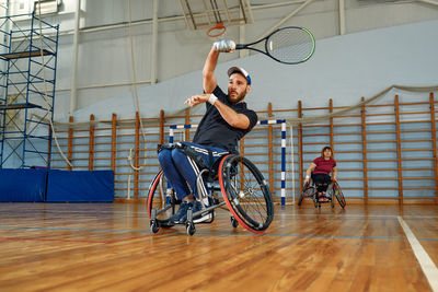 Low section of man riding bicycle on floor