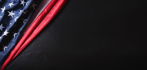 Close-up of red hanging over black background