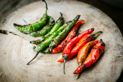 Close-up of roasted chili peppers on cutting board