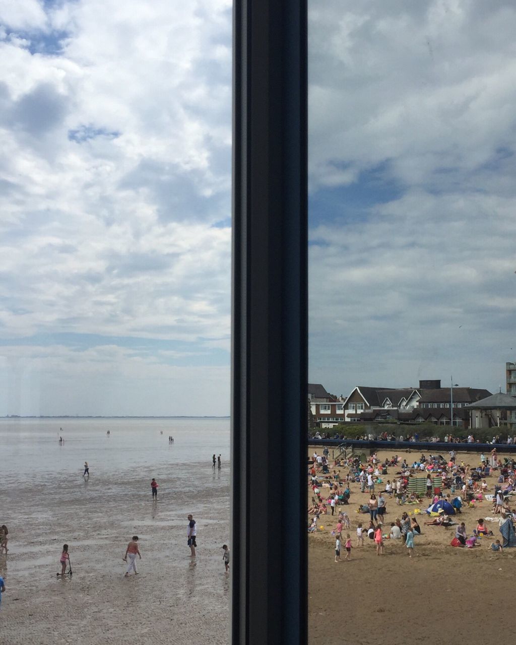 large group of people, sky, person, cloud - sky, beach, lifestyles, leisure activity, sea, window, men, built structure, architecture, cloud, indoors, vacations, water, day, crowd, glass - material