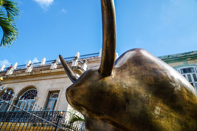 Low angle view of statue against building