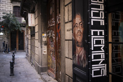 Footpath amidst buildings in city