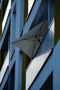 Low angle view of modern building against blue sky