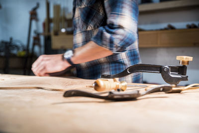 Midsection of man working in workshop