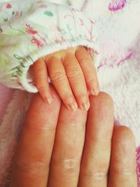 Close-up of hand touching baby