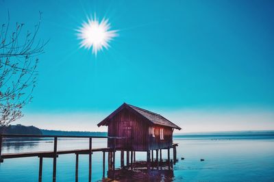 Built structure by sea against blue sky