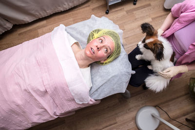 High angle view of cat sleeping on bed at home