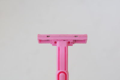 Close-up of pink toy against white background