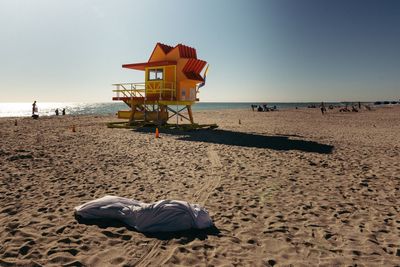 Lifeguard hut on beach against clear sky