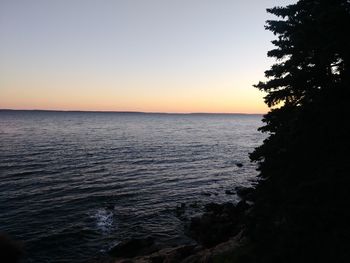 Scenic view of sea against clear sky during sunset