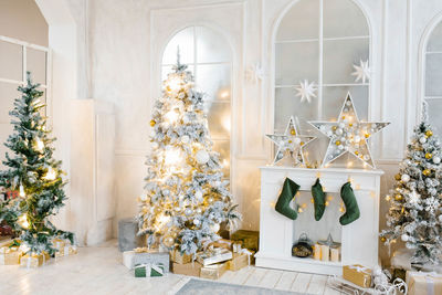 Bright cozy living room with a large elegant christmas tree, decorated for christmas