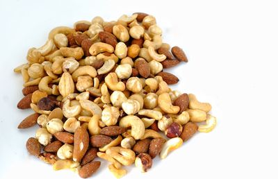 Close-up of roasted coffee beans against white background