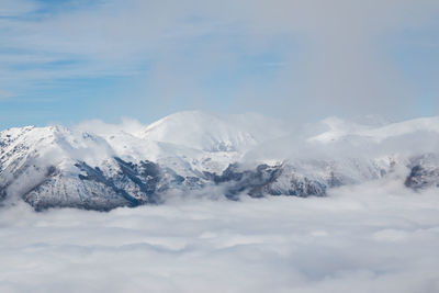 Scenic view of snowcapped mountains against sky